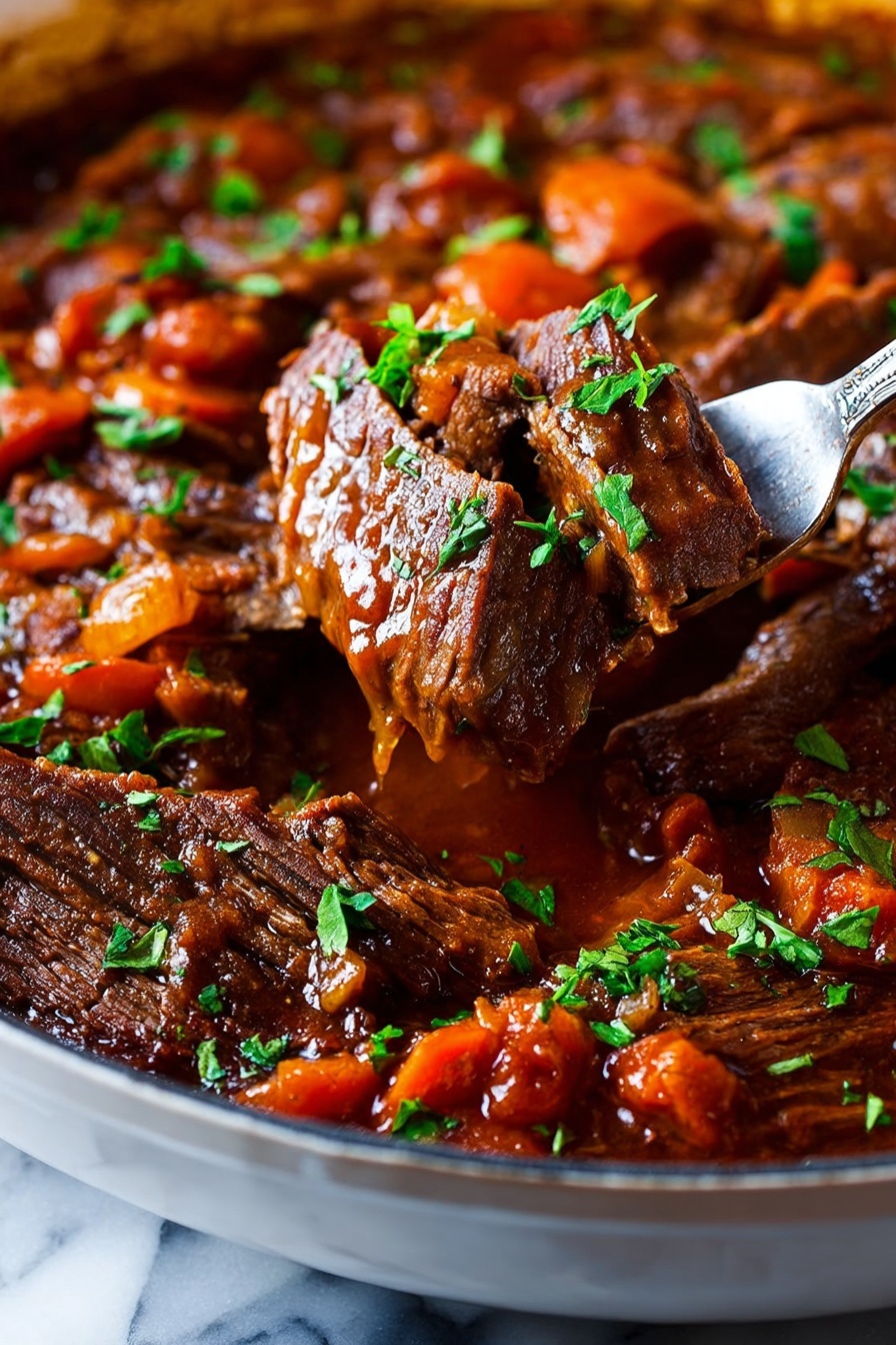 The image shows slices of cooked beef in a rich brown sauce with visible pieces of orange carrots and translucent onions. The beef is tender with a slightly rough texture, covered with a thick reddish-brown sauce that pools around the meat. Small green parsley leaves are scattered on top, adding a fresh touch. A silver fork is holding one slice of beef, lifting it above the white pan filled with the meat and sauce. The background surface is white marble, enhancing the dish's warm colors. photo taken with an iphone --ar 2:3 --v 7