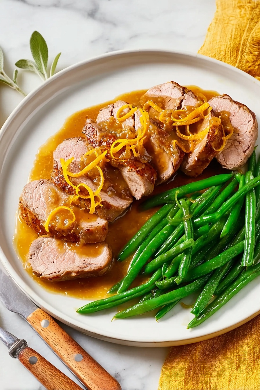 A white plate sits on a white marbled surface with six slices of cooked duck arranged in a curved line on the left side, each piece showing a light pink center and a browned outer edge, topped with a golden-brown sauce and thin strips of orange zest. On the right side of the plate, there is a neat pile of bright green steamed green beans, smooth and shiny. A silver fork with a wooden handle rests to the right of the plate on the surface, and a yellow cloth is partly visible under the plate on the left side. In the top left corner, part of an amber-colored glass with a drink is visible photo taken with an iphone --ar 2:3 --v 7
