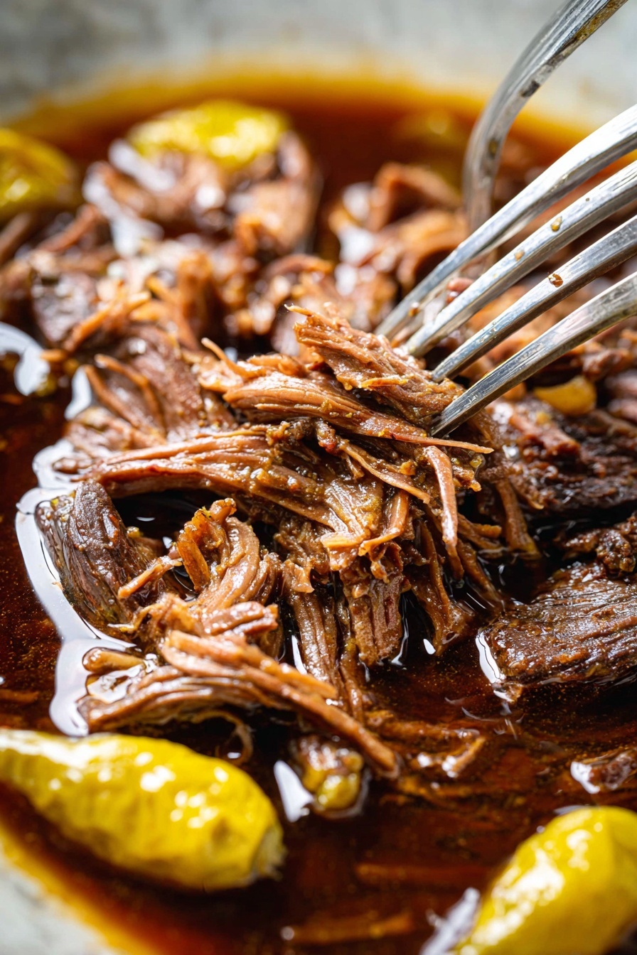 A white plate holds two main layers: the bottom layer is creamy mashed potatoes, smooth and white, spread in a circular mound; on top is a generous pile of shredded brown meat with a slightly glossy look, mixed with three whole yellow peppers. Small green herb pieces are sprinkled over the meat and mashed potatoes, adding touches of green. A fork with a wooden handle rests on the left side of the plate, partially on the mashed potatoes. The plate sits on a white marbled surface scattered with a few green herb leaves and black pepper specks. In the background, there is a bowl with pepper and another plate of the same dish, along with a small dish of yellow peppers. photo taken with an iphone --ar 2:3 --v 7
